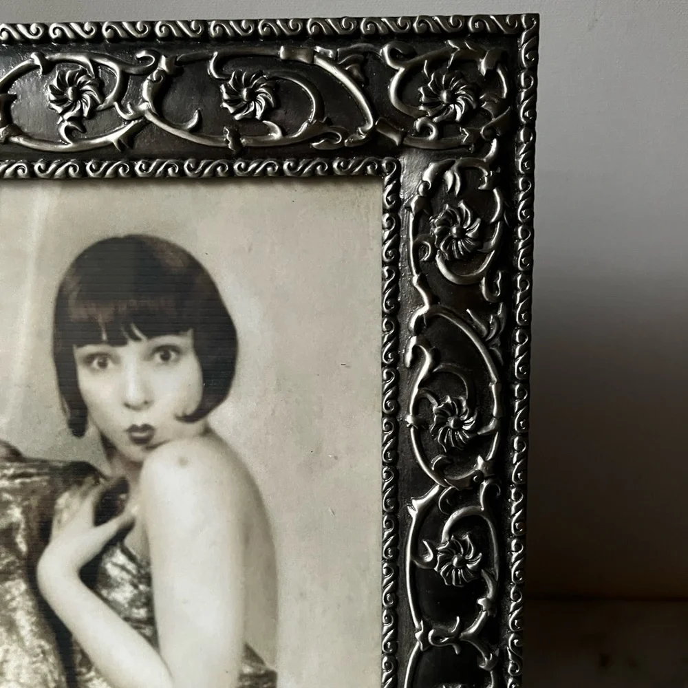 Large ornate silver Frame for photo 8”x10” free standing..